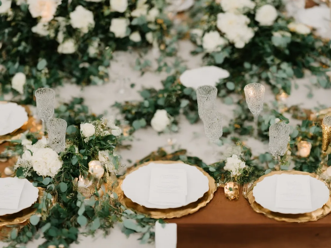 Floral reception table with a soft botanical centerpiece